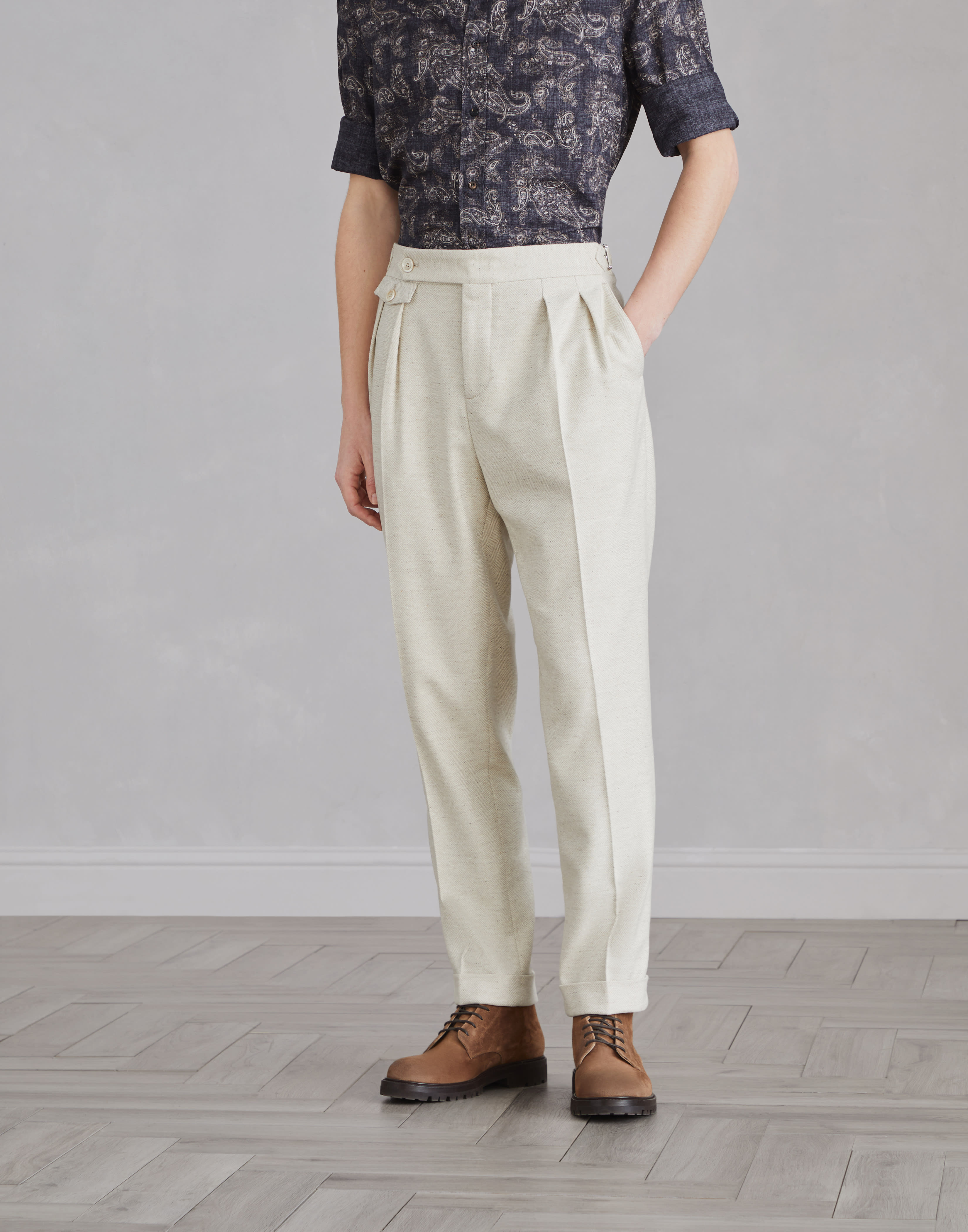 Trousers with pleats and buckles