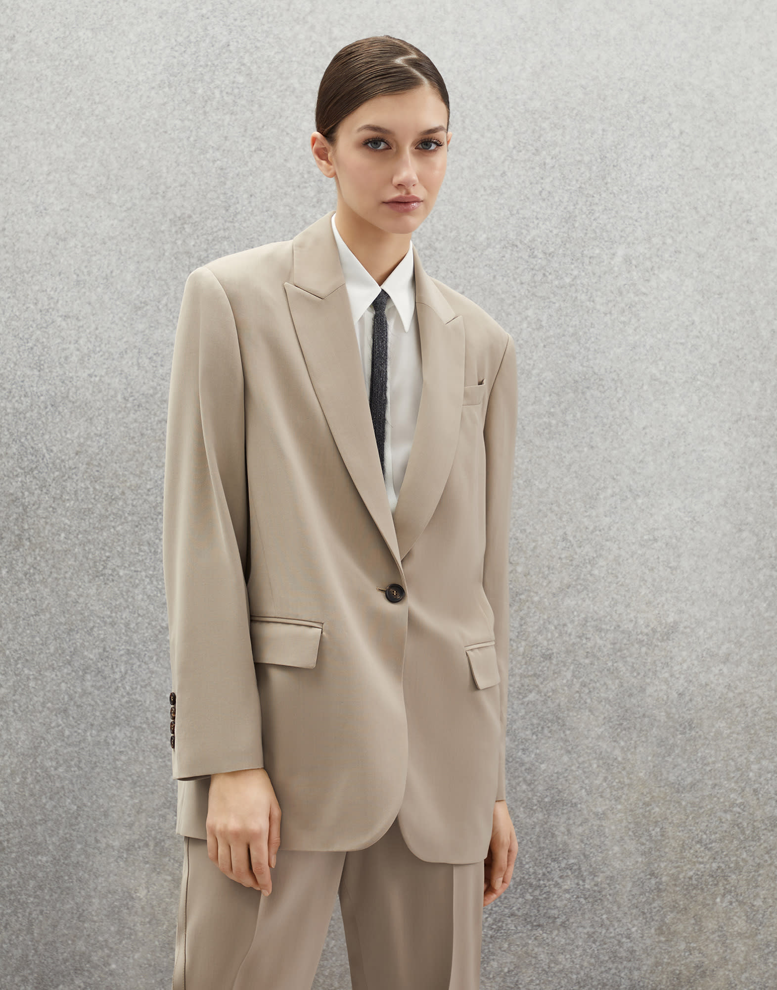 beige blazer with black buttons